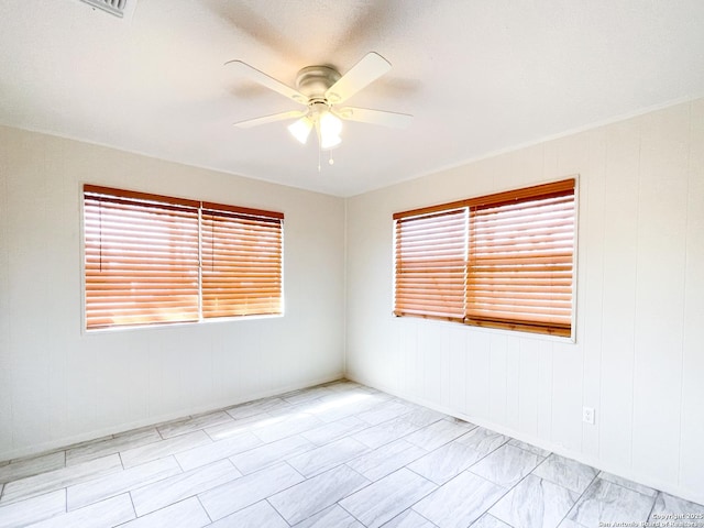 unfurnished room with a ceiling fan