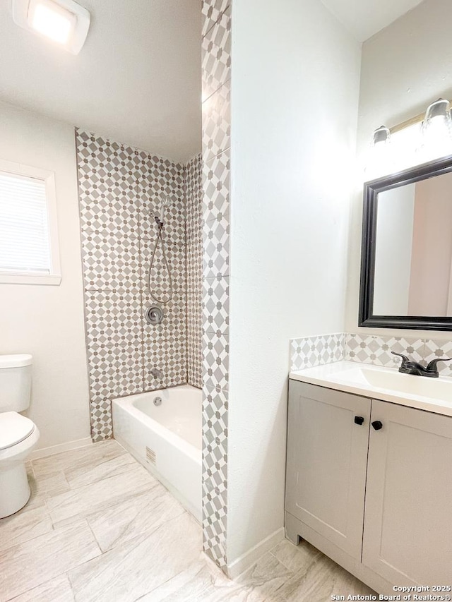 bathroom featuring shower / bathing tub combination, baseboards, toilet, and vanity