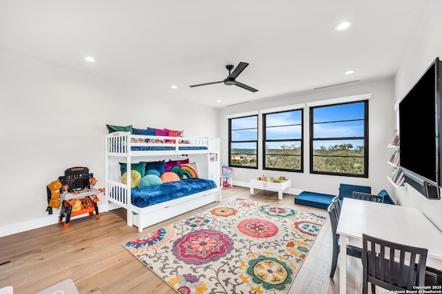 bedroom with a ceiling fan, recessed lighting, wood finished floors, and baseboards