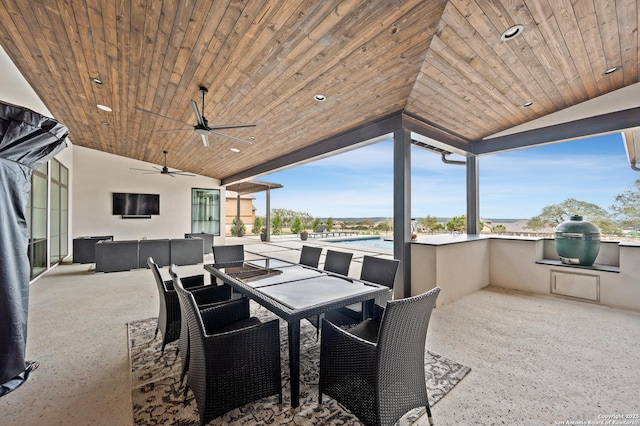 view of patio / terrace featuring area for grilling, an outdoor kitchen, ceiling fan, and outdoor dining space