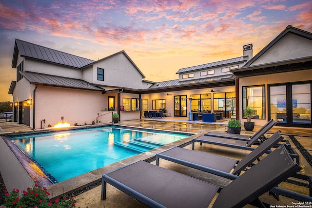 outdoor pool featuring a patio and ceiling fan