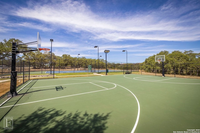 view of basketball court featuring community basketball court and fence