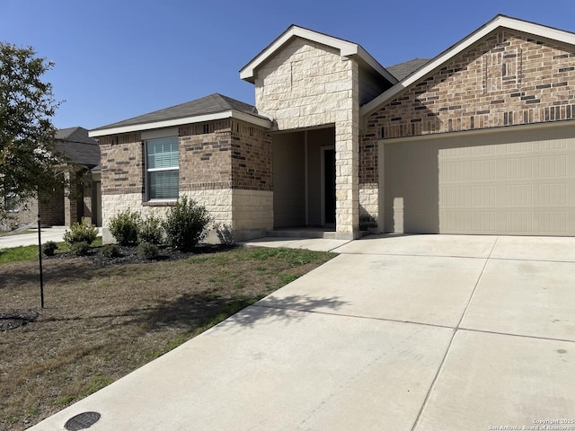 view of front of house featuring brick siding, an attached garage, and concrete driveway