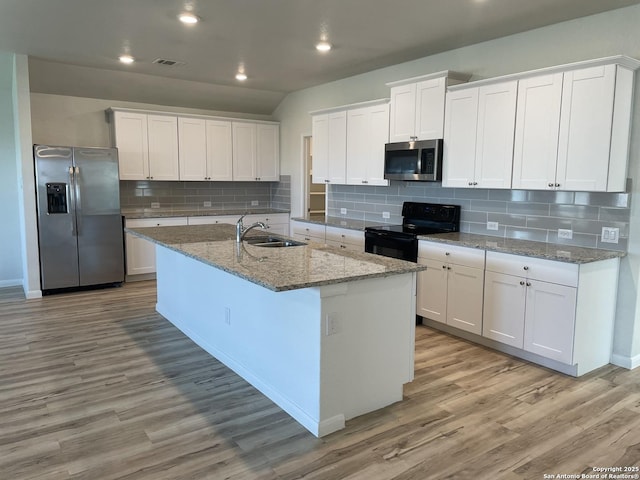 kitchen with stainless steel appliances, white cabinetry, and light wood finished floors