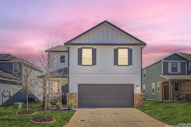 traditional home featuring board and batten siding, concrete driveway, an attached garage, brick siding, and central AC unit