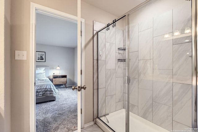 ensuite bathroom with a shower stall, ensuite bathroom, and baseboards