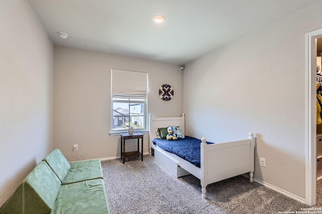 bedroom featuring baseboards and carpet floors