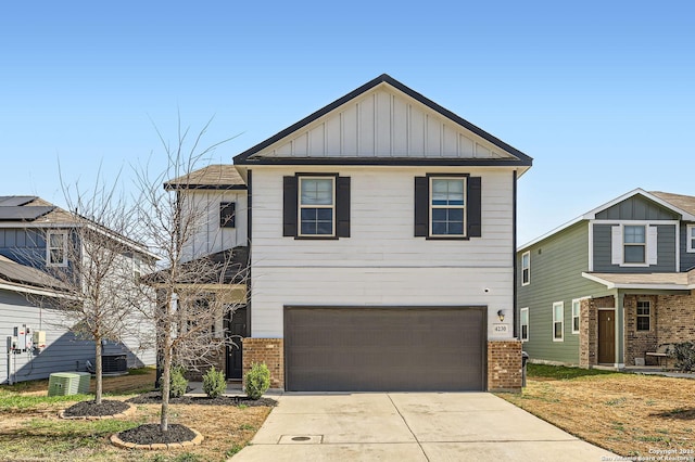 view of front of house with cooling unit, an attached garage, brick siding, concrete driveway, and board and batten siding