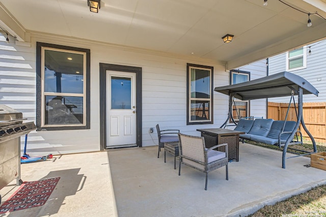 view of patio / terrace with an outdoor living space and fence