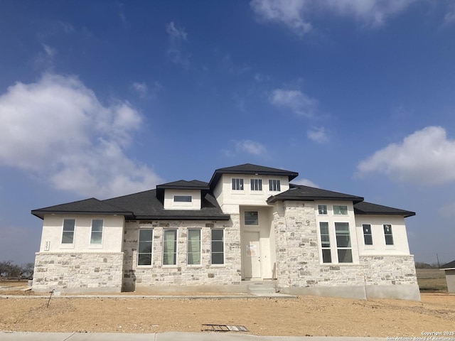 prairie-style home featuring stone siding