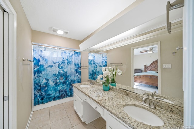 bathroom featuring tile patterned flooring, double vanity, and a sink