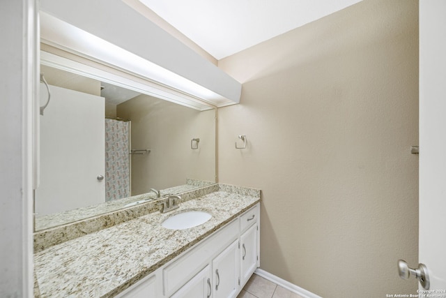 full bathroom featuring tile patterned floors, vanity, and baseboards