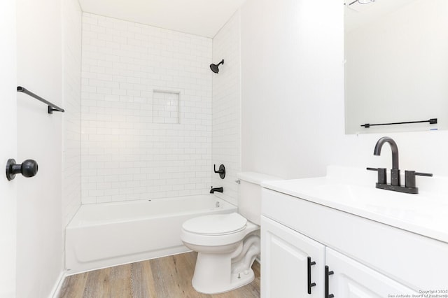 full bath featuring tub / shower combination, toilet, wood finished floors, and vanity