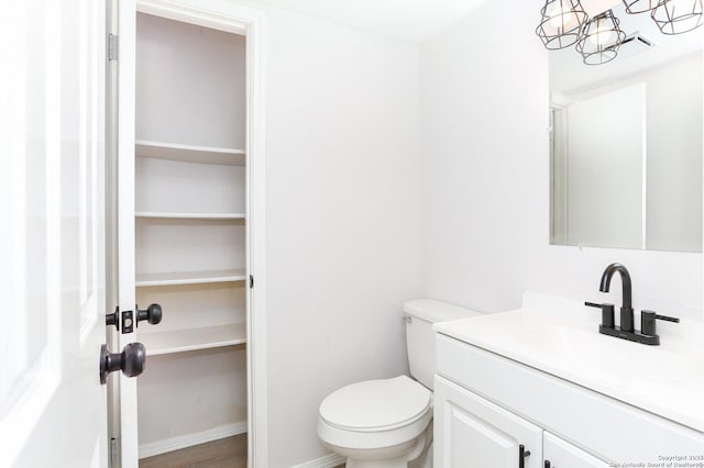 bathroom featuring toilet and vanity