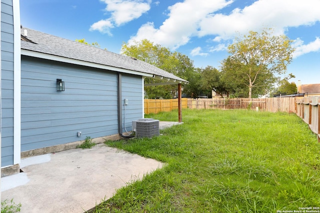 view of yard with central air condition unit, a patio area, and fence