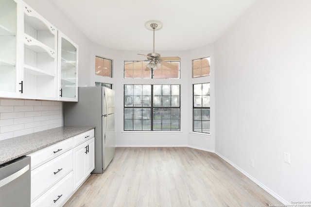 kitchen featuring dishwasher, decorative backsplash, white cabinets, a ceiling fan, and open shelves