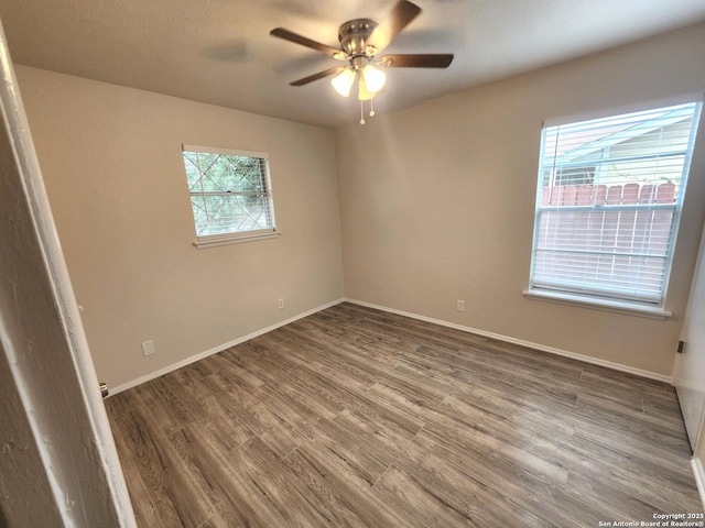 unfurnished bedroom with ceiling fan, baseboards, and wood finished floors