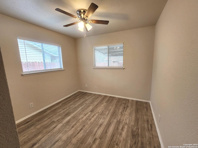 unfurnished room featuring baseboards, a textured ceiling, wood finished floors, and a ceiling fan