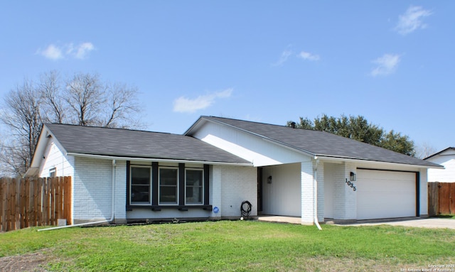 ranch-style house featuring a front yard, fence, an attached garage, concrete driveway, and brick siding