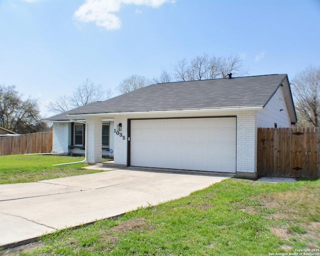 ranch-style home featuring a front lawn, fence, concrete driveway, an attached garage, and brick siding