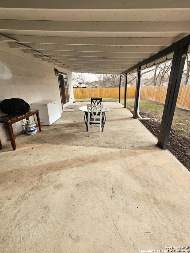 view of patio / terrace featuring fence