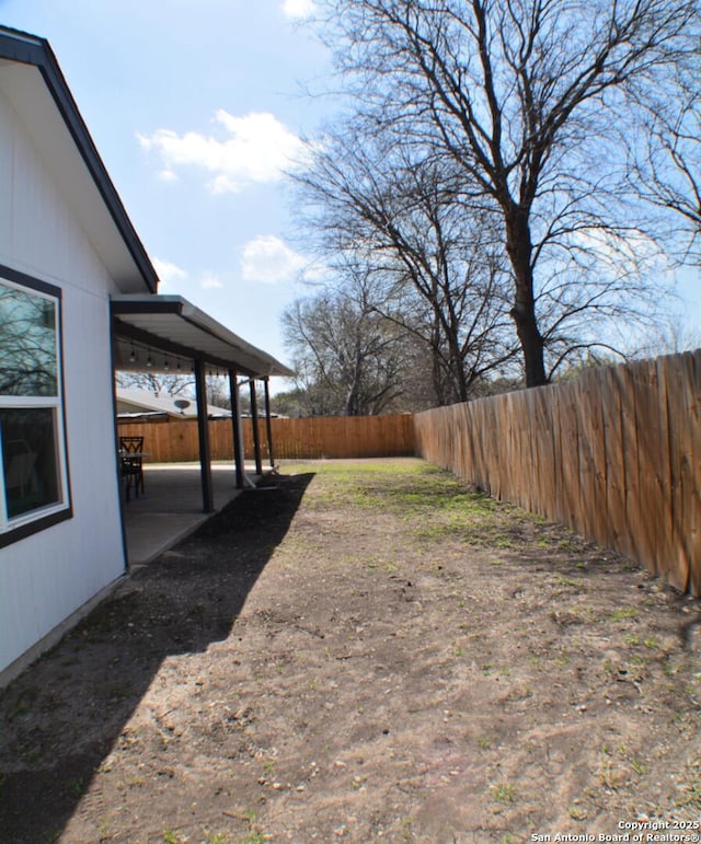 view of yard featuring a patio and a fenced backyard