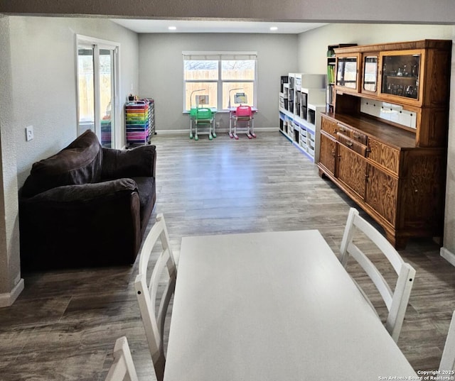 living room featuring recessed lighting, wood finished floors, and baseboards