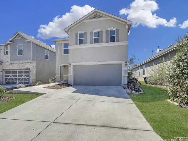 view of front of property featuring a front yard, a garage, driveway, and stucco siding