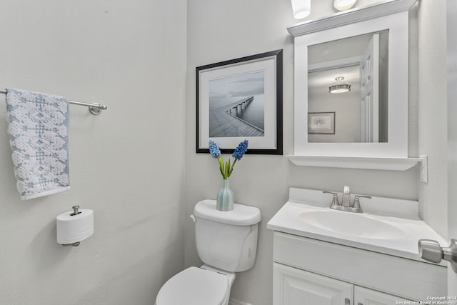 half bath featuring toilet and vanity