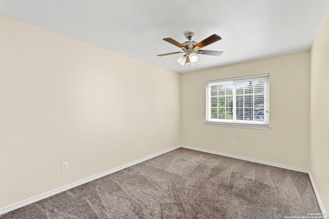 carpeted empty room with baseboards and ceiling fan