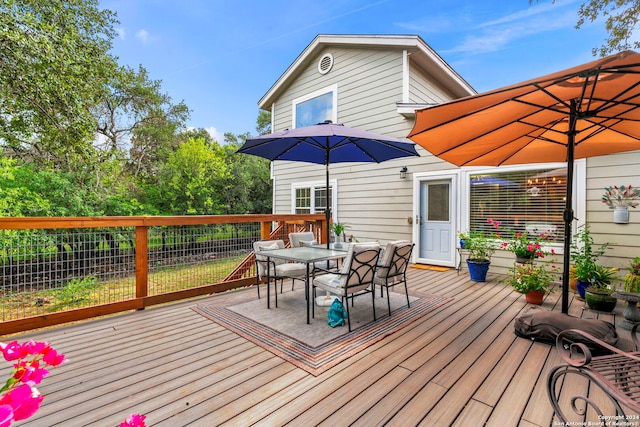 wooden deck featuring outdoor dining area