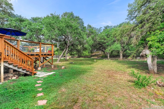 view of yard with stairs and a deck