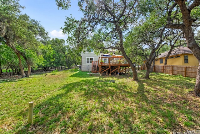 view of yard with stairway, a deck, and fence