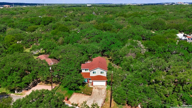 birds eye view of property with a view of trees