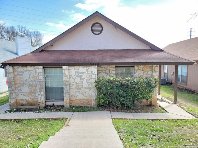 view of front of property with central AC unit and a chimney