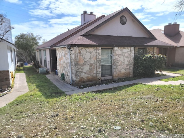 exterior space featuring a lawn and a chimney