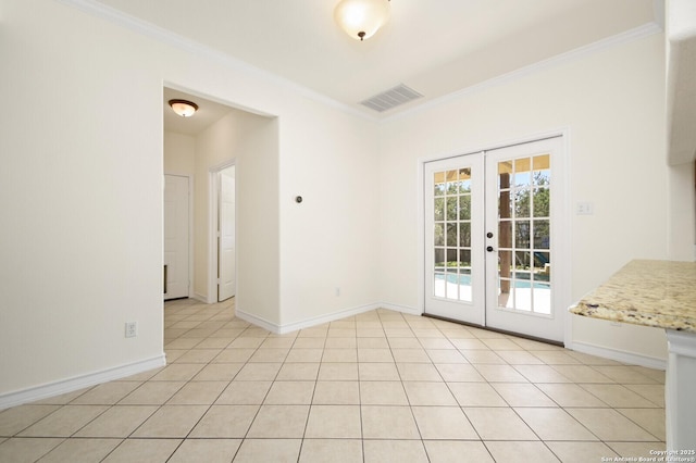 interior space with light tile patterned floors, french doors, visible vents, and crown molding