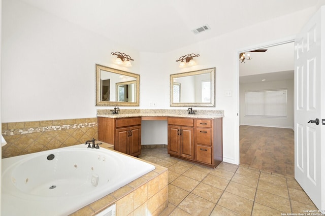 full bathroom featuring vanity, tile patterned floors, visible vents, and a whirlpool tub