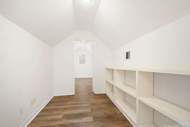 bonus room with visible vents, lofted ceiling, baseboards, and wood finished floors