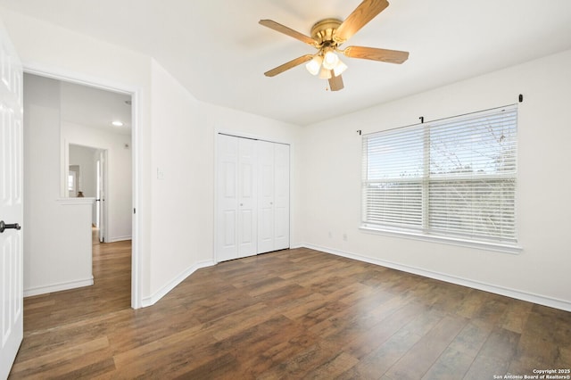unfurnished bedroom featuring a closet, a ceiling fan, baseboards, and wood finished floors