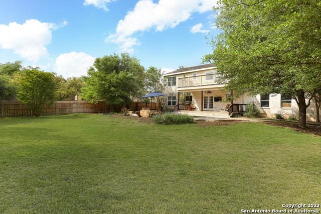 view of yard with a patio area, french doors, and fence private yard