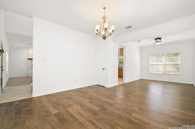 spare room with wood finished floors, visible vents, baseboards, ornamental molding, and ceiling fan with notable chandelier