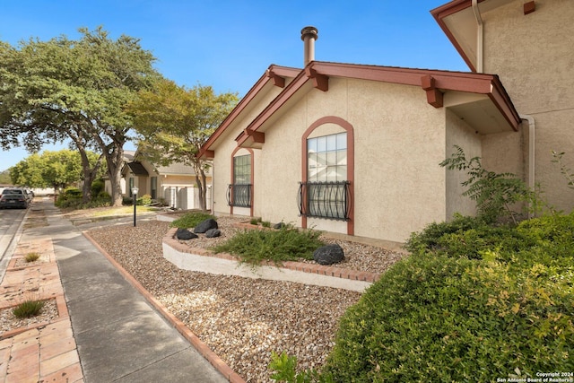 view of side of home with stucco siding