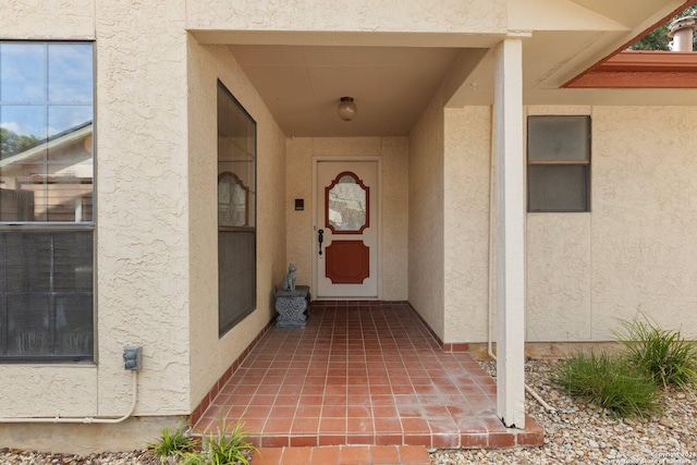 property entrance with stucco siding