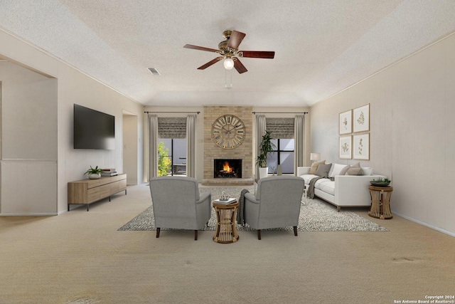 living area featuring a ceiling fan, a textured ceiling, a fireplace, and carpet flooring