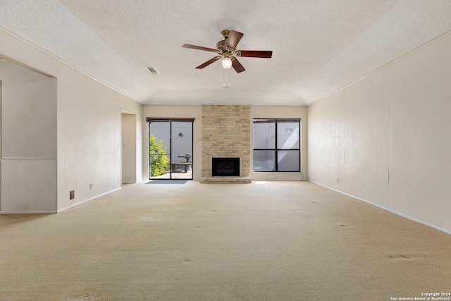 unfurnished living room with a textured ceiling, a healthy amount of sunlight, ceiling fan, and carpet flooring