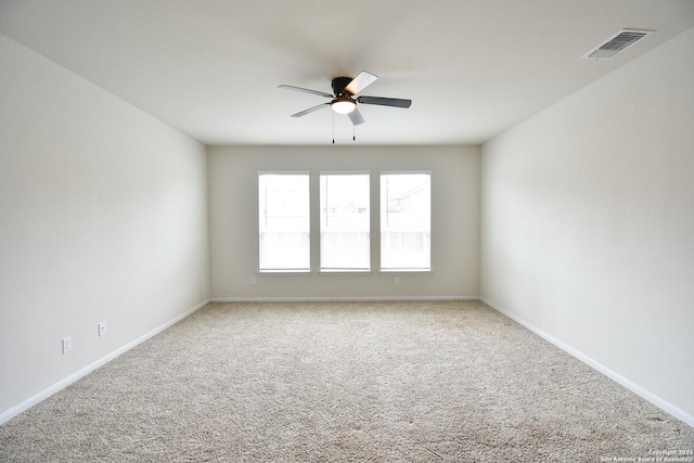 unfurnished room featuring visible vents, baseboards, ceiling fan, and carpet flooring