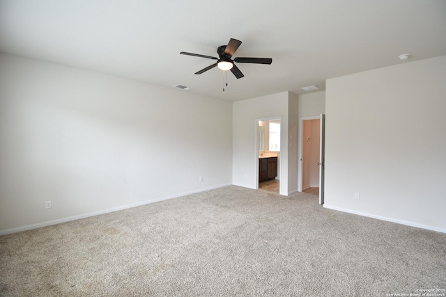 empty room with visible vents, baseboards, light colored carpet, and a ceiling fan