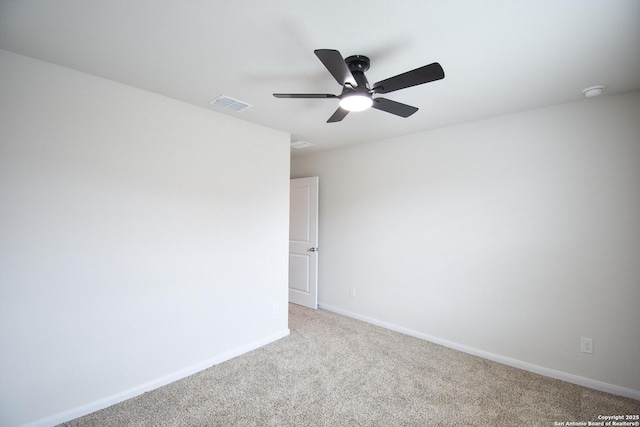 carpeted empty room featuring visible vents, baseboards, and a ceiling fan