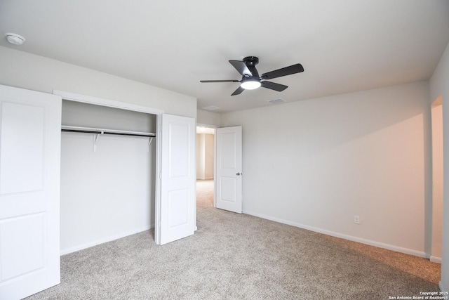 unfurnished bedroom featuring carpet, visible vents, a closet, and baseboards